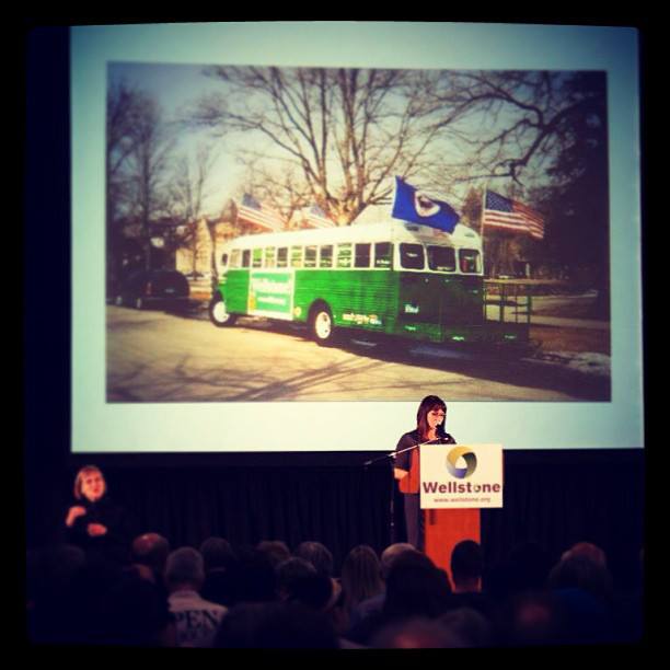 Peggy Flanagan stands at a podium